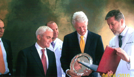 Dr. Bucci presenting Former President Clinton with a certificate & engraved silver plate